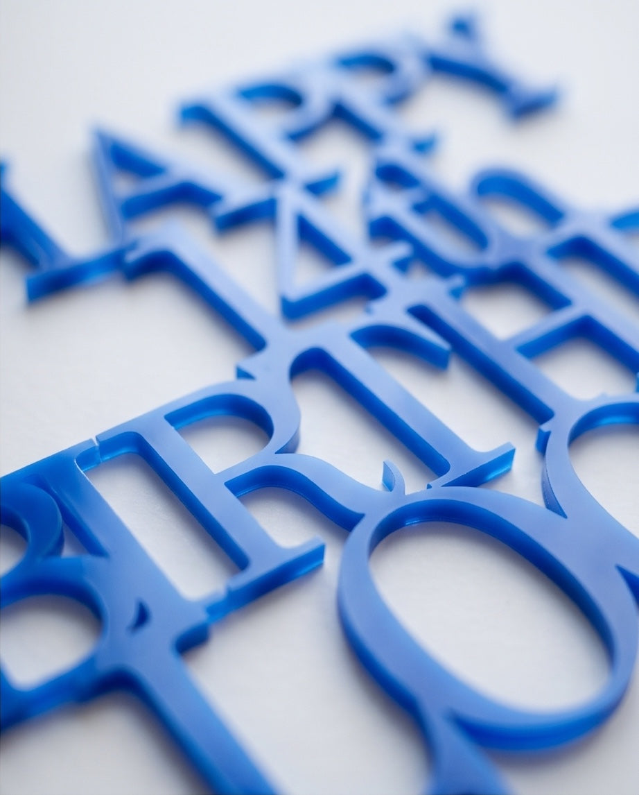 Close-up detail of blue acrylic personalised birthday cake topper